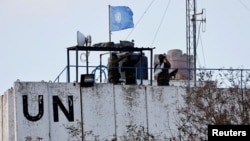 FILE PHOTO: United Nations peacekeepers (UNIFIL) look at the Lebanese-Israeli border