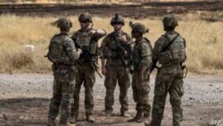 US soldiers stand at an oil field in the countryside of al-Qahtaniyah town in Syria's northeastern Hasakeh province near the Turkish border, on Aug. 4, 2020.