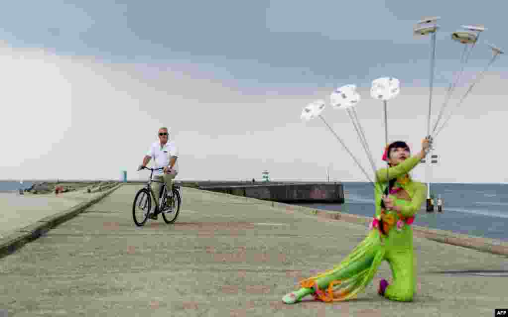 Acrobats of the China National Acrobatic Troupe take part in a presentation at Scheveningen harbour, the Netherlands.