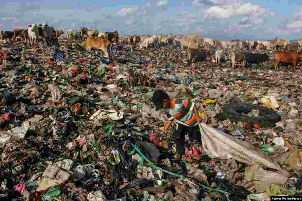 A boy searches for useable items at a garbage dump in Antang, Indonesia.
