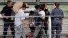 Ever Castillo, left, and his family, immigrants from Honduras, are escorted back across the border by U.S. Customs and Border Patrol agents, June 21, 2018, in Hildalgo, Texas. The parents were told they would be separated from their children.