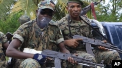 Republican forces troops allied with President Alassane Ouattara drive through the village of Keibly, just outside Blolequin in western Ivory Coast, May 31, 2011.