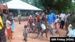 South Sudanese gather in front of the Zereda center, which increases awareness of HIV, in Western Equatoria state.