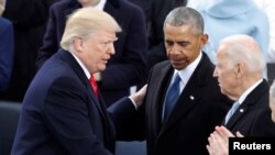 FILE PHOTO: U.S. President Donald Trump greets former Vice President Joe Biden and former President Barack Obama after being sworn in as the 45th president of the United States on the West front of the U.S. Capitol in Washington, U.S., January 20, 2017. 