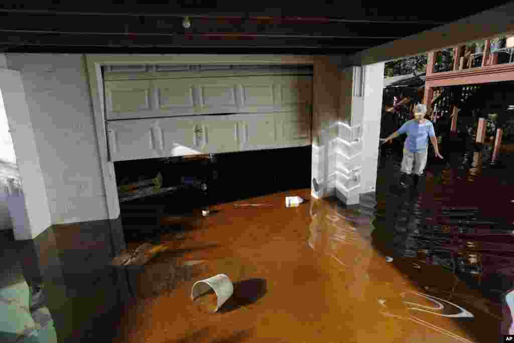 Roberta Albers walks around her home after the floodwaters start to recede at French Quarter Creek in Huger, South Carolina, USA.