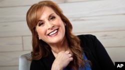 FILE - Jodi Benson, the voice of Ariel from the Disney animated film, "The Little Mermaid," poses in Nashville, Tenn., Feb. 19, 2019.