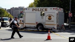 Members of the U.S. Secret Service investigate items thrown over the fence at the White House, Monday, Sept. 11, 2017, in Washington.