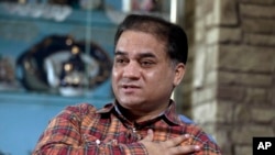 In this Feb. 4, 2013 file photo, Ilham Tohti, an outspoken scholar of China's Turkic Uighur ethnic minority, speaks during an interview at his home in Beijing, China.