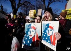 Demonstrators chants during a rally protesting the immigration policies of President Donald Trump, near the White House in Washington, Feb. 4, 2017.