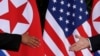 U.S. President Donald Trump and North Korea's leader Kim Jong Un meet at the start of their summit at the Capella Hotel on the resort island of Sentosa, Singapore, June 12, 2018.