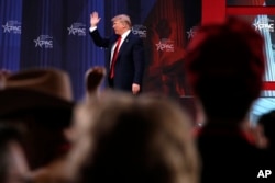 President Donald Trump waves after speaking to the Conservative Political Action Conference (CPAC), at National Harbor, Md., Feb. 23, 2018.