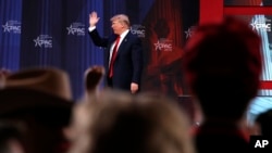 President Donald Trump waves after speaking to the Conservative Political Action Conference (CPAC), at National Harbor, Md., Feb. 23, 2018.