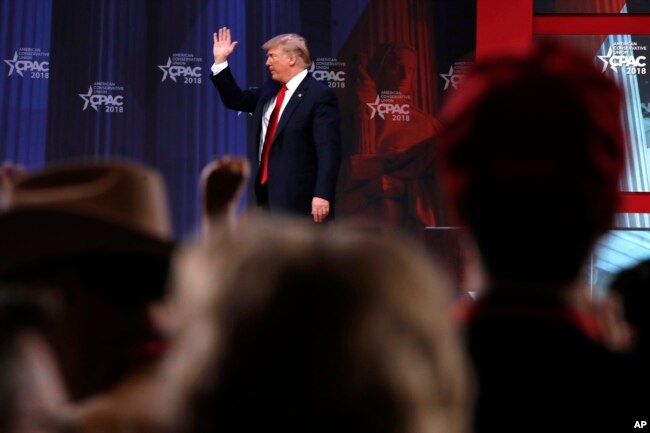 President Donald Trump waves after speaking to the Conservative Political Action Conference (CPAC), at National Harbor, Md., Feb. 23, 2018.