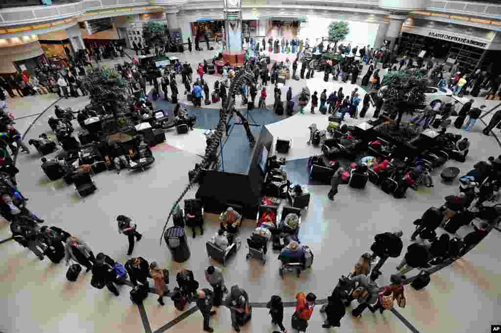 A long line of travelers winds around the atrium at Hartsfield-Jackson International Airport when operations return after the effects of a major winter storm halted flights for three days in Atlanta, Georgia, USA.