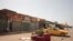 FILE - A man sits by shuttered shops in Khartoum, Sudan, Monday, April 17, 2023. Sudan's embattled capital has awoken to a third day of heavy fighting between the army and a powerful rival force for control of the country.