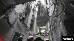 Rescuers remove debris in the regional administration building, which city officials said was hit by a missile attack, in central Kharkiv, Ukraine, March 1, 2022.