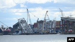 The collapsed Francis Scott Key Bridge continues to block the main shipping channel in the port at Baltimore, Maryland, April 5, 2024.