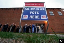 FILE - Voters wait in line to cast their ballots in Greenville, S.C., Feb. 20, 2016. Democrats and Republicans compete in primaries and caucuses in at least 11 states and one U.S. territory Tuesday.