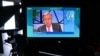 U.N. Secretary-General Antonio Guterres is seen on a TV screen addressing remotely the WEF Davos Agenda virtual sessions at the WEF's headquarters in Cologny near Geneva, Jan. 17, 2022.