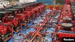 Fracking trucks at work are seen at a shale gas well of Sinopec in Nanchuan, Chongqing, China March 18, 2018. Picture taken March 18, 2018.