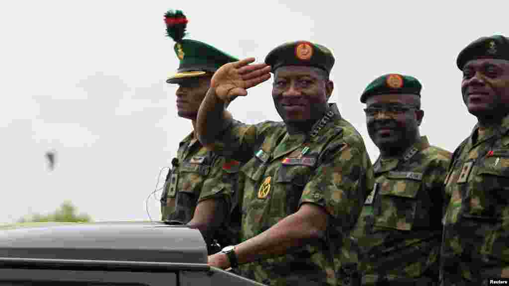 President Jonathan salutes as he parades during the Nigeria Army&#39;s 150th anniversary celebration.