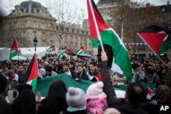 Demonstrators shout as they hold Palestinian flags during a protest against U.S. President Donald Trump's decision to recognize Jerusalem as Israel's capital, at Republique Square in Paris, France, Dec. 9, 2017.
