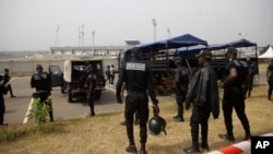 Police officers patrol the entrance of bafousam stadium before the group b soccer match between senegal and guinea at the african cup of nations 2022 in bafousam, cameroon on january 14, 2022.