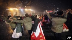 North Koreans dance on the Kim Il Sung Square to celebrate a satellite launch, Feb. 8, 2016, in Pyongyang, North Korea. 