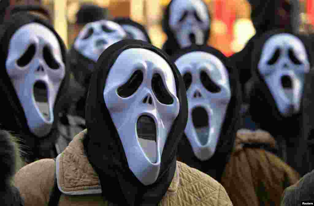 Postal workers wear masks during a protest in front of the state-owned postal service Posta Romana headquarters in Bucharest, Romania, against the treatment by the management.