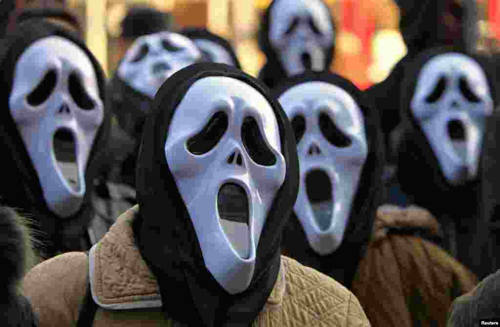 Postal workers wear masks during a protest in front of the state-owned postal service Posta Romana headquarters in Bucharest, Romania, against the treatment by the management. 