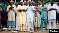 Muslims pray outside a school during celebrations marking Eid al-Adha in Lagos October 15, 2013.