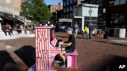 Street Pianos: In this Sunday, Sept. 25, 2016 photo Scott Frazer, of Medford, Mass., plays a piano on the sidewalk in the Harvard Square neighborhood of Cambridge, Mass. A number of working pianos painted by local artists have been placed around Boston and Cambridge, each with a simple message to passersby: "Play Me, I'm Yours." 