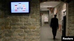 FILE - A staffer of the NATO Cooperative Cyber Defense Center of Excellence is seen walking through a restricted operational area of the center in Tallinn, Estonia.