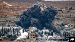 In this file photo on Nov. 17, 2014, smoke rises from the Syrian city of Kobani, following an airstrike by the US led coalition. (AP Photo/Vadim Ghirda)