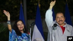 Nicaragua's incumbent president Daniel Ortega and his wife, vice presidential candidate Rosario Murillo, left, wave at supporters after casting their ballots in Managua, Nov. 6, 2016. 