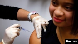 FILE - An influenza vaccination in Boston, Jan 10, 2013. 