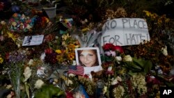 A photo of Heather Heyer, who was killed during a white nationalist rally, sits on the ground at a memorial in Charlottesville, VA.