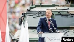 FILE - Poland's President Andrzej Duda speaks as he attends the Polish National Army Day parade in Warsaw, Poland, Aug. 15, 2018.