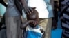 March 9, 2012: A boy who fled a war across the border in Sudan's Blue Nile state waits outside a clinic in Doro refugee camp. Peace in Sudan remains uneasy at best, with the north and south deadlocked over oil transit fees that have contributed to recent 