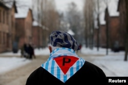 FILE - A survivor is seen at the former Nazi German concentration and extermination camp Auschwitz, as he attends ceremonies marking the 74th anniversary of the liberation of the camp and International Holocaust Victims Remembrance Day, in Oswiecim, Poland.