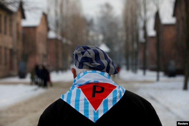 FILE - A survivor is seen at the former Nazi German concentration and extermination camp Auschwitz, as he attends ceremonies marking the 74th anniversary of the liberation of the camp and International Holocaust Victims Remembrance Day, in Oswiecim, Poland.