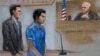 In this courtroom sketch, defendant Dias Kadyrbayev, center, a college friend of Boston Marathon bombing suspect Dzhokhar Tsarnaev, is depicted, Aug. 21, 2014 in federal court in Boston during a hearing.