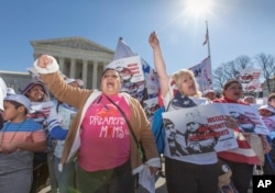 FILE - Immigration activists demonstrate at the Supreme Court in Washington in support of President Barack Obama's executive order to grant relief from deportation in order to keep immigrant families together, March 18, 2016.