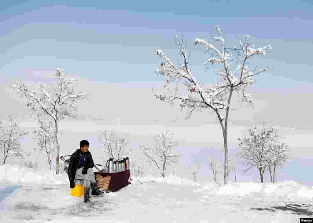 A man waits for customers at a tea stall near Qargha Lake in Kabul, Afghanistan.