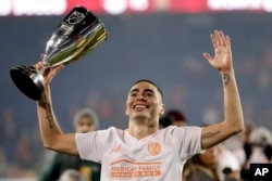 애틀란타 유나티드의 미구엘 알미론 선수가 메이저리그 축구(MLS) 동부 컨퍼런스 챔피언쉽에서 승리한 후 받은 트로피를 들어보이고 있다.