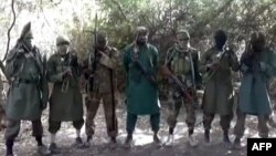 A picture taken from a video reportedly shows Abubakar Shekau (C), the suspected leader of Nigerian Islamist extremist group Boko Haram, flanked by six armed and hooded fighters in an undisclosed place, March 5, 2013.