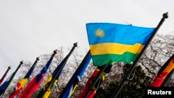 FILE - The national flag of Rwanda flies amongst other flags.