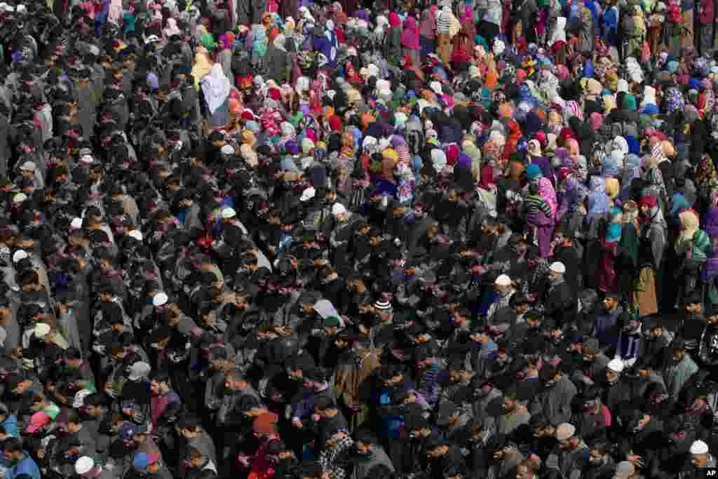 Kashmiri villagers pray by the body of Sahir Ahmed, a rebel as they participate in his funeral in Arwani, 55 kilometers south of Srinagar, Indian controlled Kashmir.