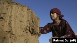 In this Wednesday, June 19, 2019, photo, Hameda, 8, works at a brick factory on the outskirts of Kabul, Afghanistan. The U.S. and its allies have sunk billions of dollars of aid into Afghanistan since the invasion to oust the Taliban 18 years ago.