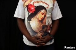 An expat worshipper wears a shirt with St. Rita's picture at St. Francis of Assisi Catholic Church in Jebel Ali, as Catholics await a historic visit by Pope Francis to United Arab Emirates, in Dubai, UAE, Jan. 25, 2019.